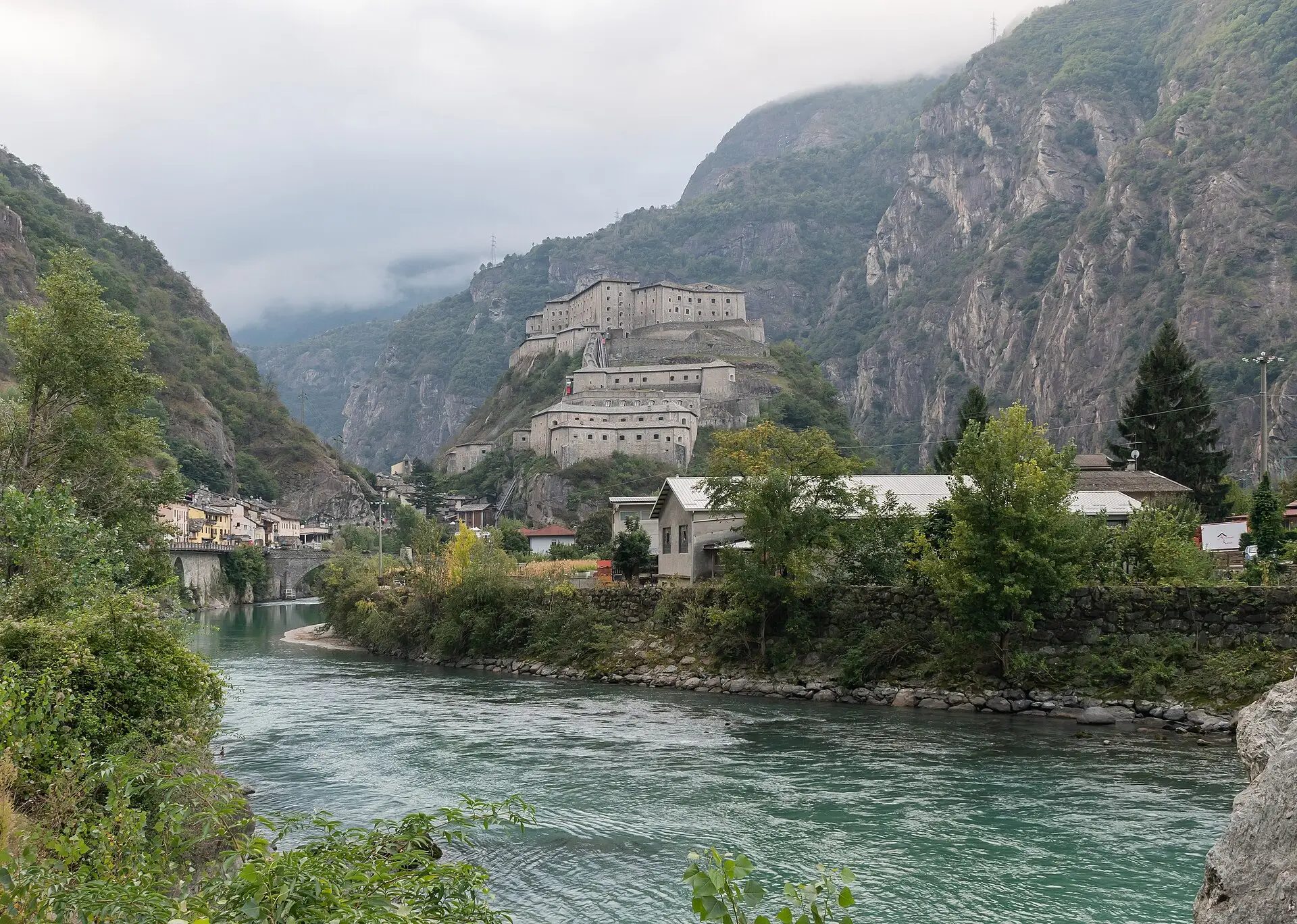 Forte di Bard rising above the Dora Baltea river on a fortified rock — an Aosta Valley alpine fortress.