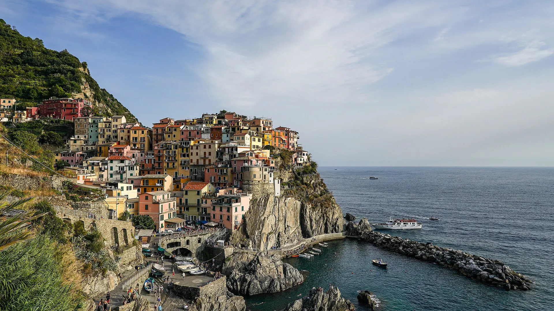 Manarola, Cinque Terre — the classic postcard view of pastel houses stacked above the small harbour.