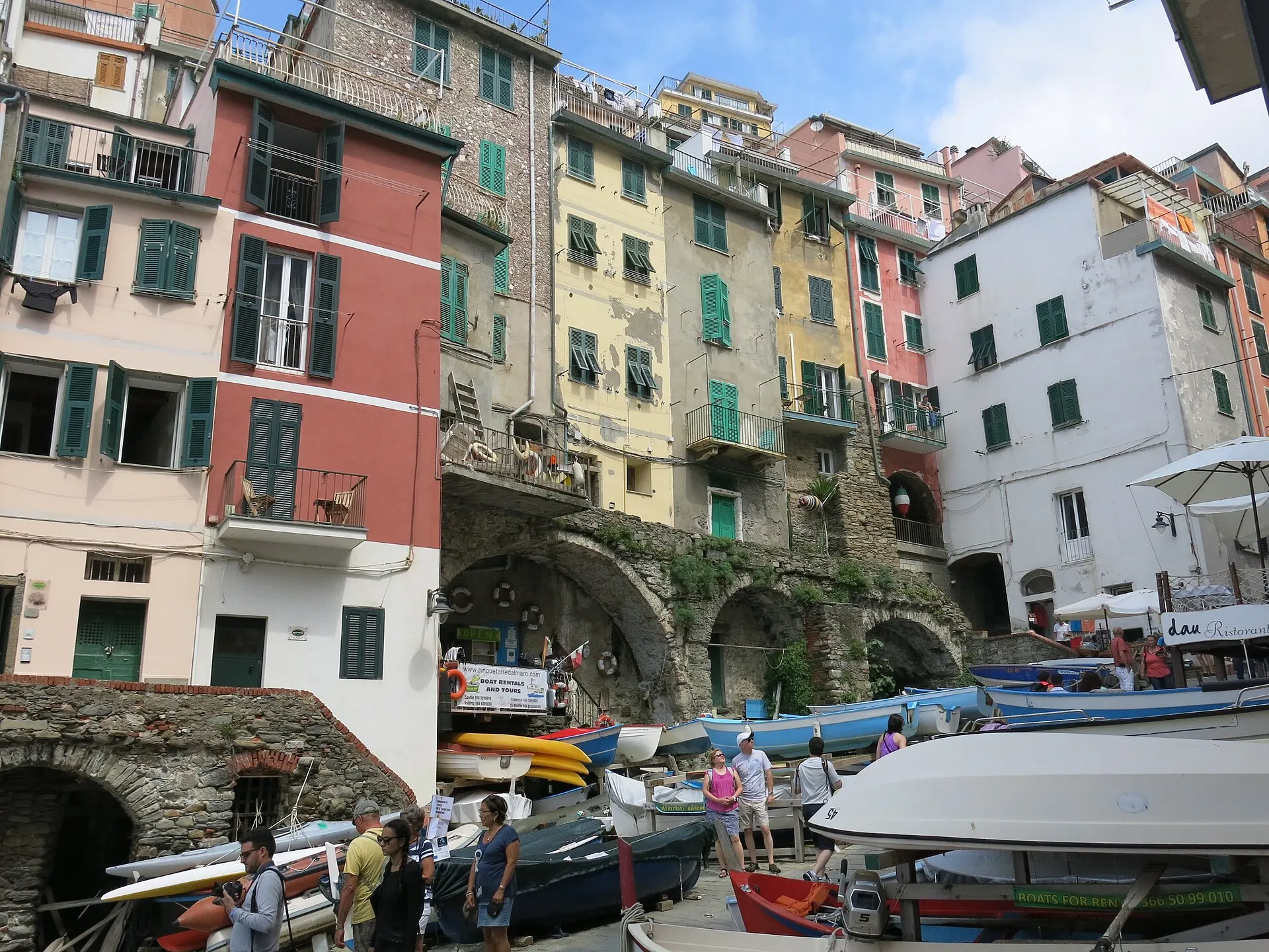 Riomaggiore's harbour — colourful pastel houses tumbling down to fishing boats pulled up by the marina.