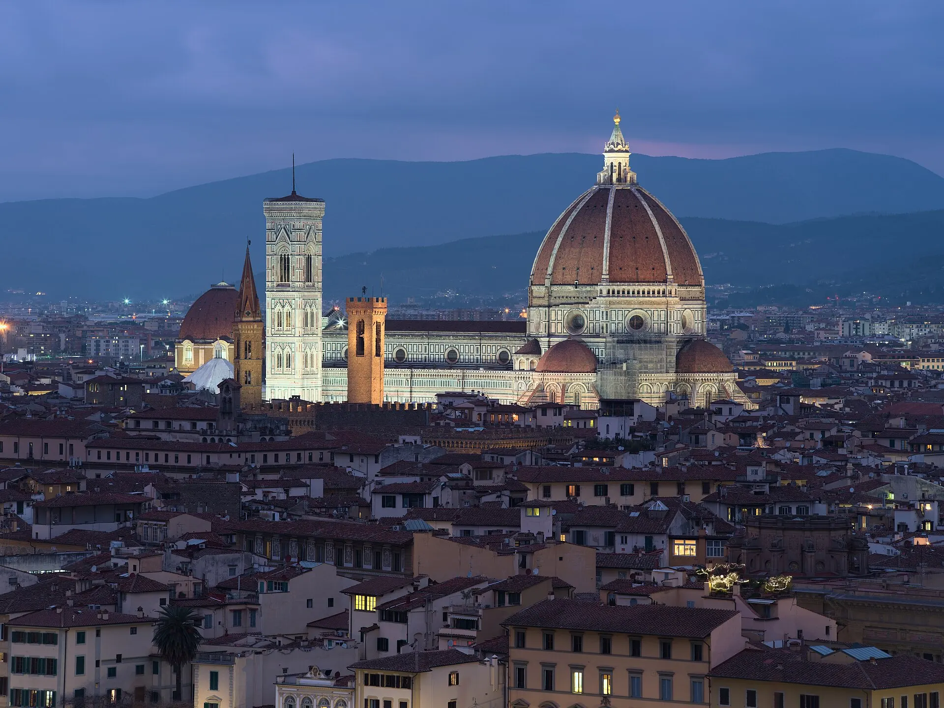 Florence at twilight from Piazzale Michelangelo — the Duomo and Campanile rising above the city's terracotta roofs.