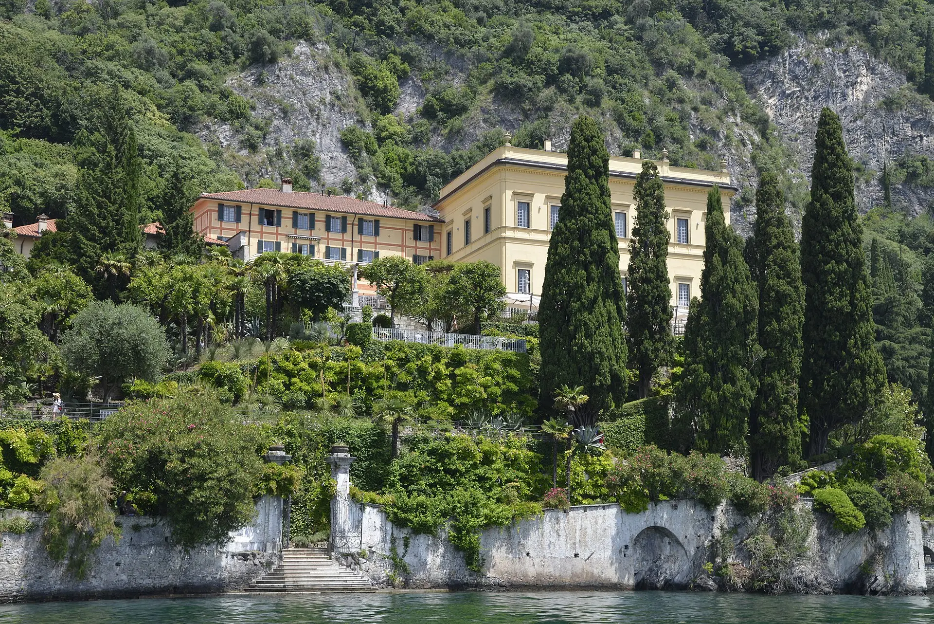 Villa Cipressi in Varenna — yellow lakeside villa with terraced gardens and cypresses descending to the water.