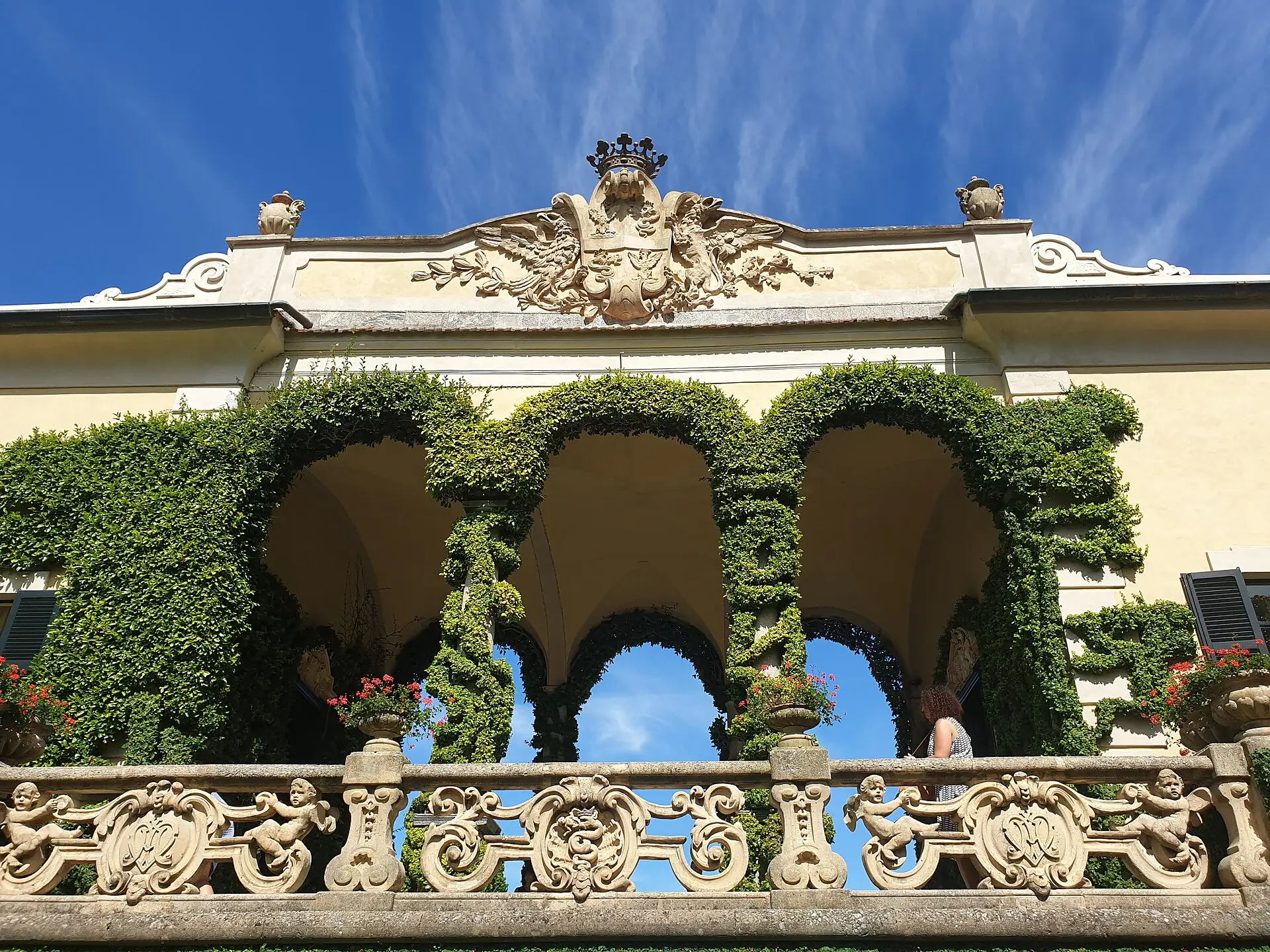 Villa del Balbianello — the famous ivy-arched loggia with cherub statues and carved balustrade above Lake Como at Lenno.